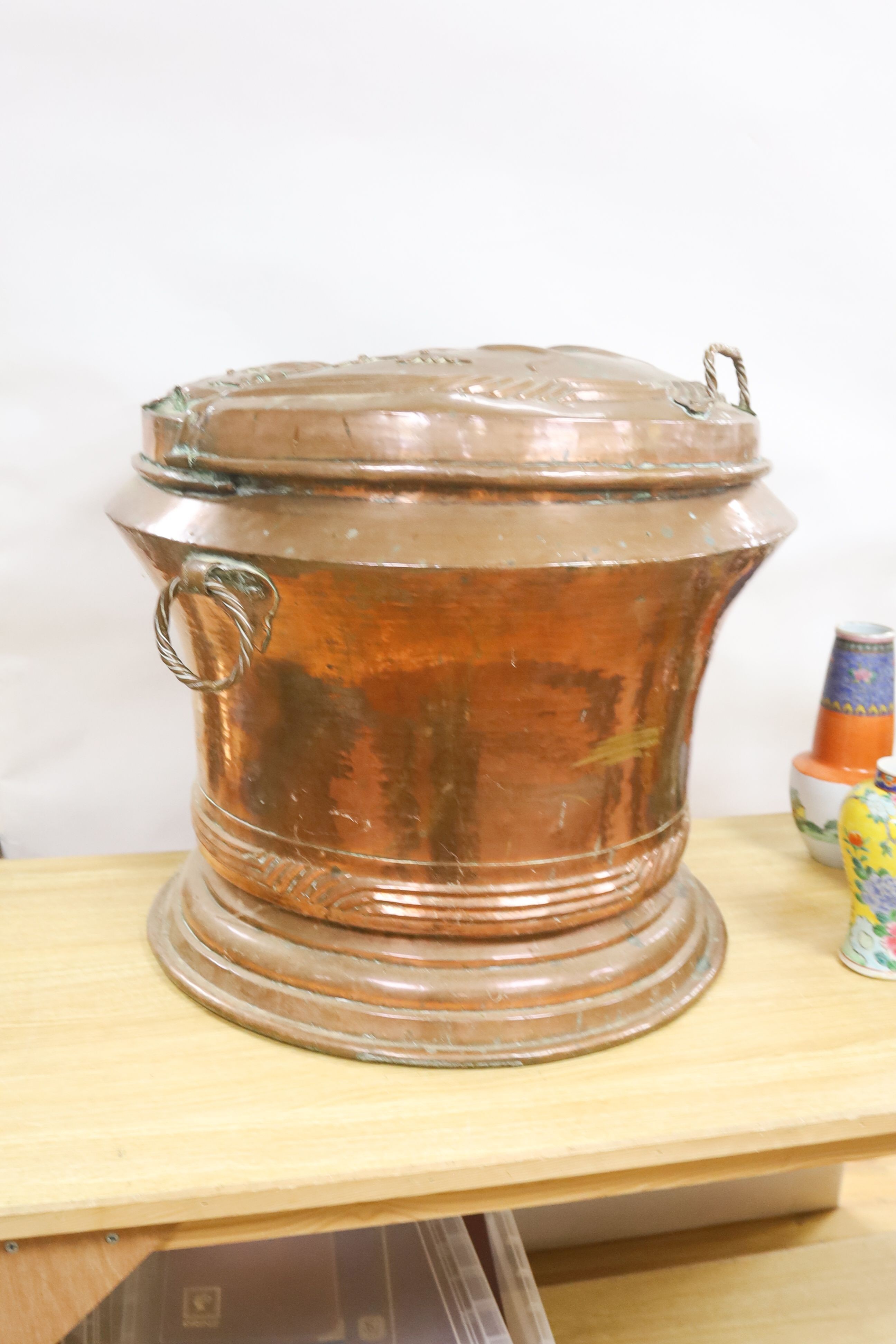 A large French provincial Art Nouveau copper lidded bin with handles 57cm